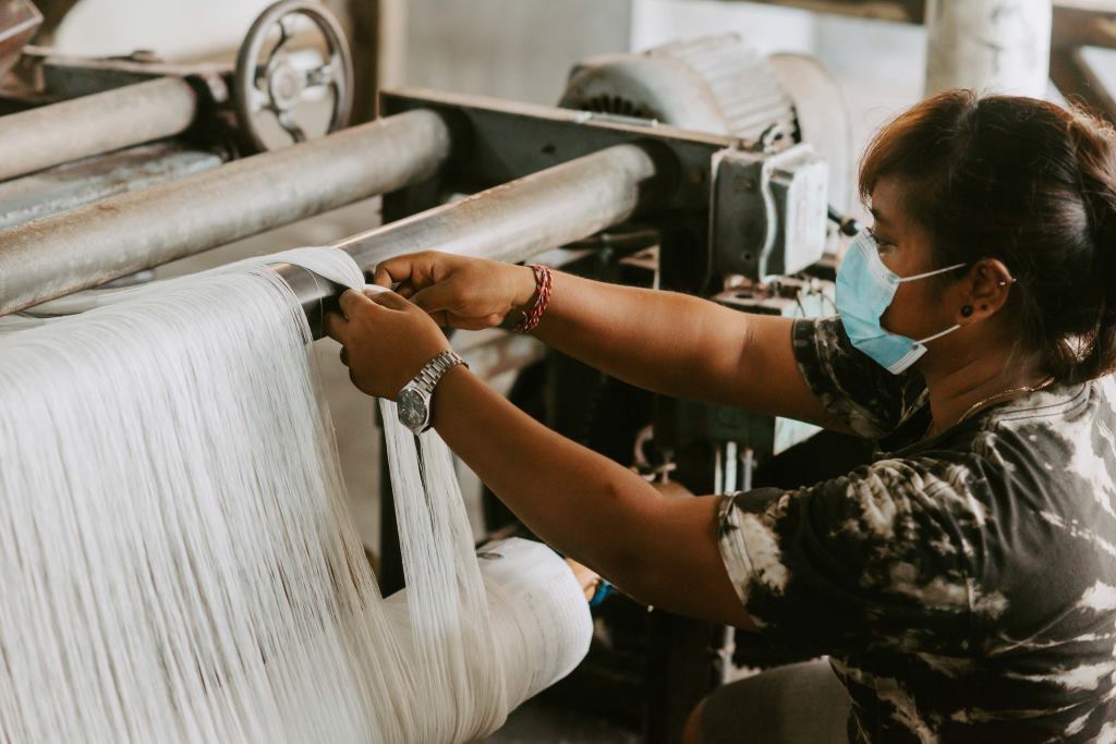 Bali weaver preparing loom for Orba Ghost Sneaker upper weaving 